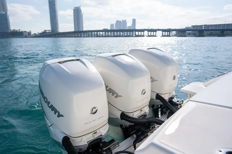 Slide: The Image of Triple Mercury outboard engines on a 2020 Boston Whaler 380 Outrage, with city skyline backdrop. - 11