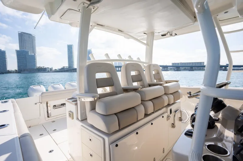 Slide: The Image of 2020 Boston Whaler 380 Outrage interior with luxurious seating, city skyline in background. - 12