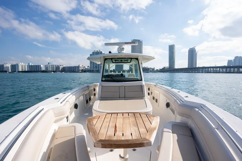 Slide: The Image of Boston Whaler 380 Outrage 2020 on water, city skyline in background, sunny day. - 15