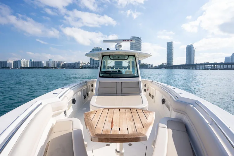 Slide: The Image of 2020 Boston Whaler 380 Outrage boat on water with city skyline background. - 16