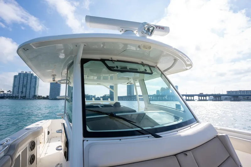 Slide: The Image of Boston Whaler 380 Outrage 2020 on water, city skyline in background. - 21