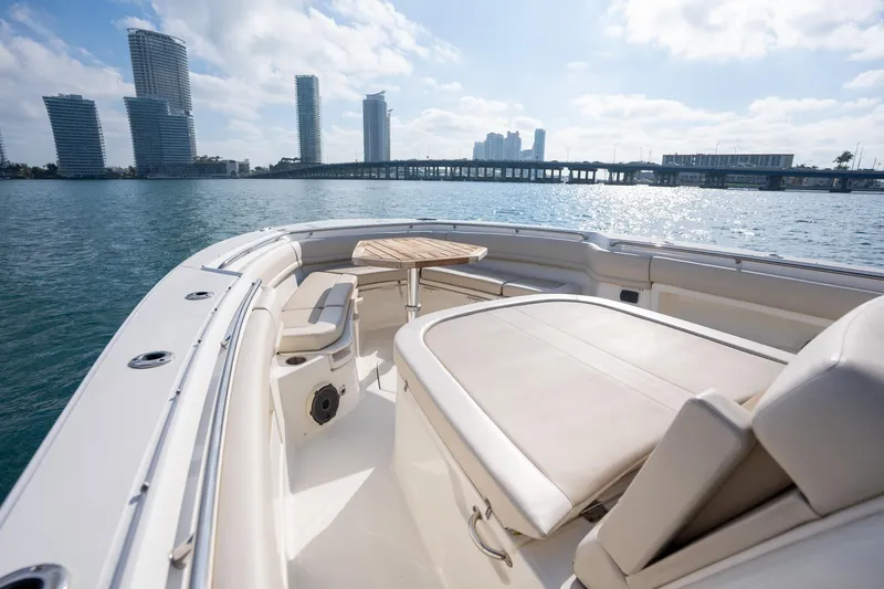Slide: The Image of 2020 Boston Whaler 380 Outrage boat with city skyline and bridge in background. - 22