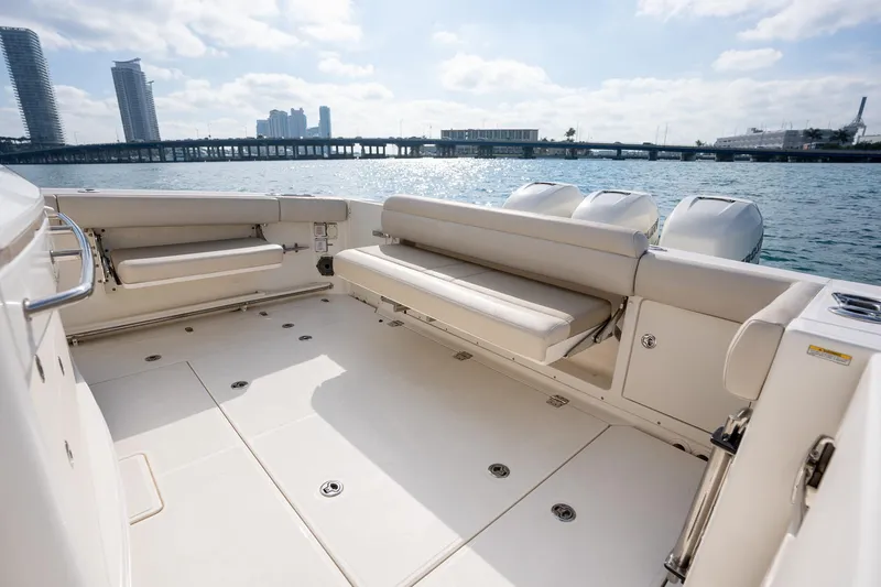 Slide: The Image of 2020 Boston Whaler 380 Outrage boat interior with seating, overlooking water and cityscape. - 31