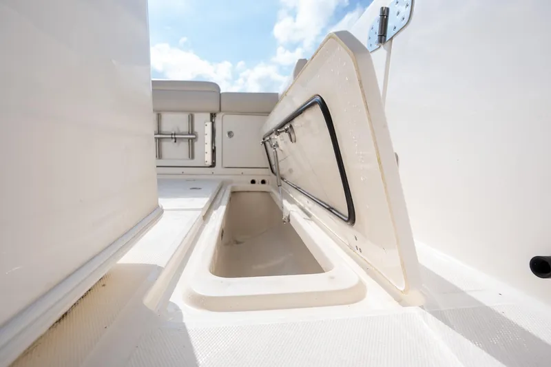 Slide: The Image of 2020 Boston Whaler 380 Outrage storage compartment open under clear sky. - 36