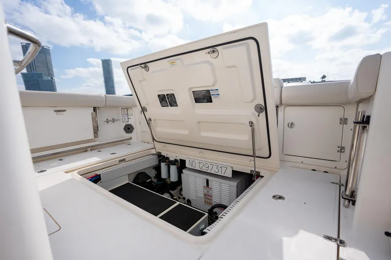 Slide: The Image of 2020 Boston Whaler 380 Outrage boat with open storage compartment, showcasing interior details. - 38