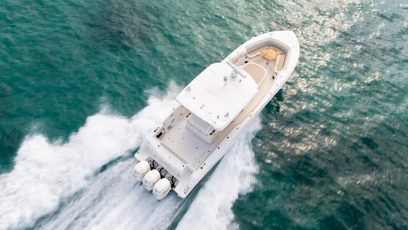 Slide: The Image of 2020 Boston Whaler 380 Outrage cruising on clear blue water, aerial view. - 6