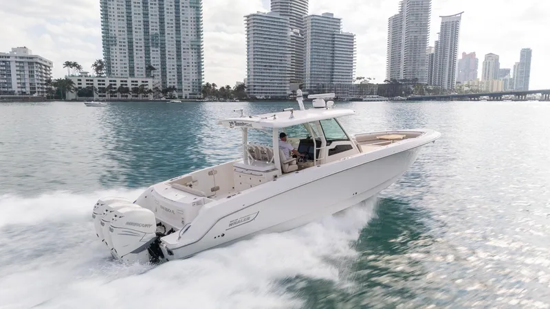 Slide: The Image of 2020 Boston Whaler 380 Outrage cruising in urban waterfront setting. - 7