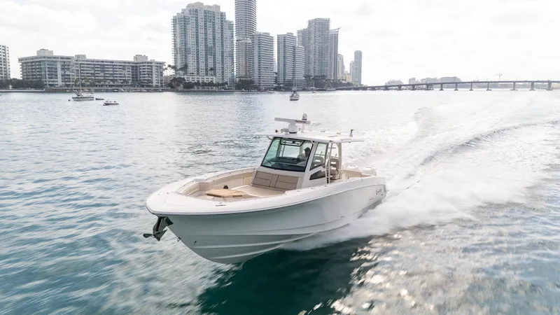 Slide: The Image of 2020 Boston Whaler 380 Outrage cruising in urban waterfront setting. - 8