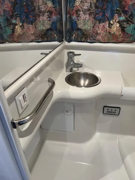 Slide: The Image of Compact bathroom sink area in a 1996 Formula 330 SS boat. - 12