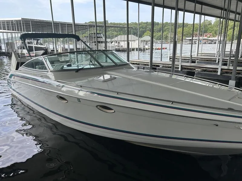 Slide: The Image of 1996 Formula 330 SS boat docked in a marina, featuring sleek design and spacious deck. - 17
