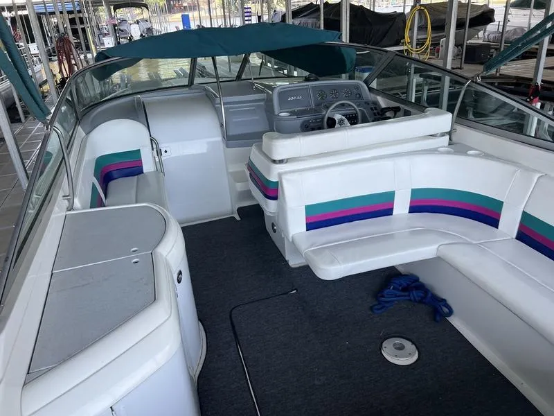Slide: The Image of Interior of a 1996 Formula 330 SS boat with white seating and colorful accents. - 3