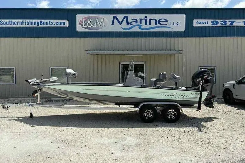 Slide: The Image of 2026 Xpress H22 Bay boat on trailer outside I&M Marine dealership. - 0