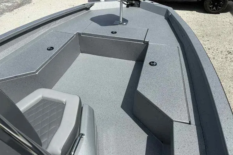 Slide: The Image of 2026 Xpress H22 Bay boat interior with gray seating and storage compartments. - 10