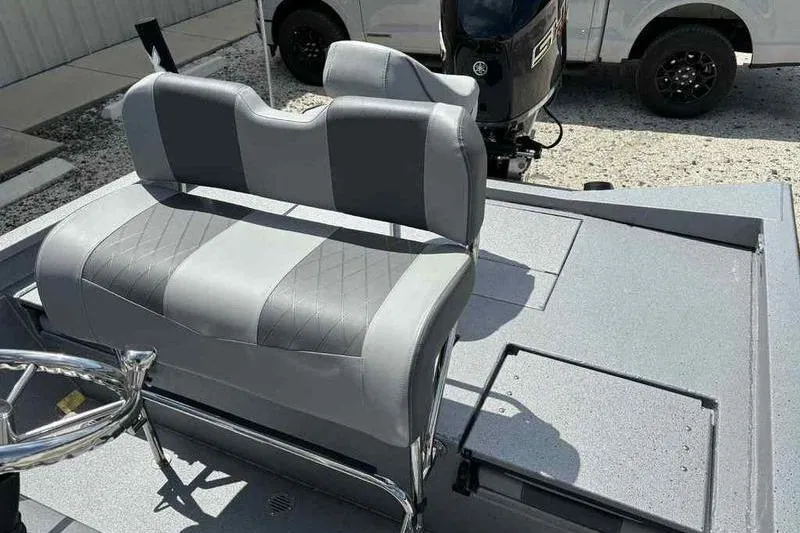 Slide: The Image of 2026 Xpress H22 Bay boat interior with gray seating and steering wheel. - 11