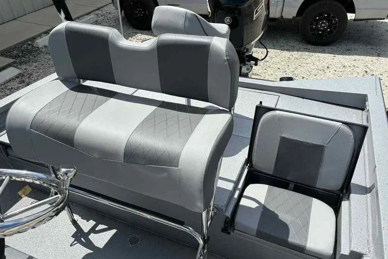 Slide: The Image of 2026 Xpress H22 Bay boat seats, featuring gray and black upholstery with diamond stitching. - 13