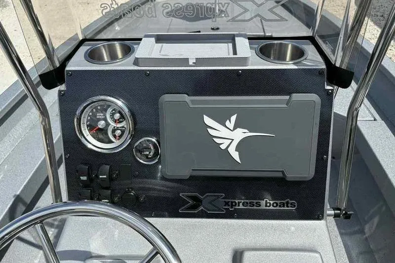 Slide: The Image of 2026 Xpress H22 Bay boat dashboard with gauges and logo. - 3