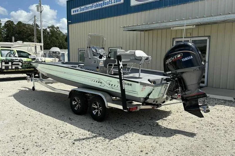 Slide: The Image of 2026 Xpress H22 Bay boat with Yamaha engine on trailer outside dealership. - 4
