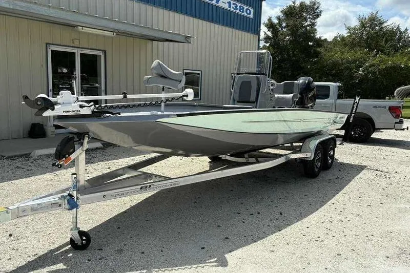 Slide: The Image of 2026 Xpress H22 Bay boat on trailer outside a building. - 5