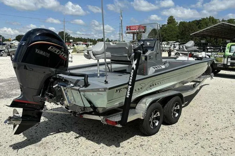 Slide: The Image of 2026 Xpress H22 Bay boat with Yamaha engine on a trailer, parked outdoors. - 9