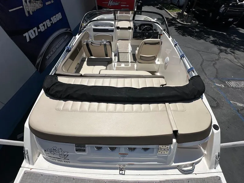 Slide: The Image of 2017 Bayliner VR5 Bowrider boat interior with beige seating and steering wheel. - 11