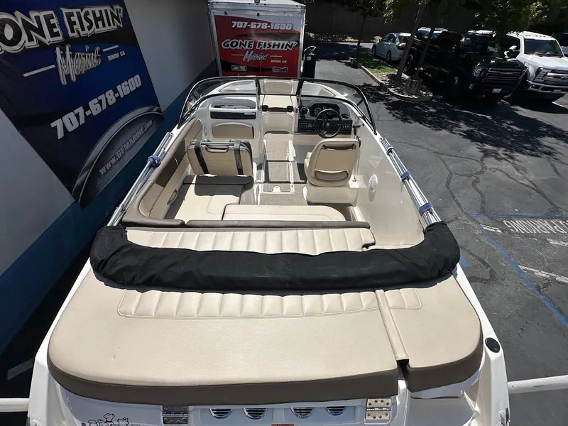 Slide: The Image of 2017 Bayliner VR5 Bowrider boat interior with beige seating and steering wheel. - 12