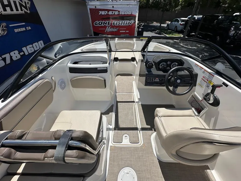 Slide: The Image of 2017 Bayliner VR5 Bowrider interior with beige seating and modern dashboard controls. - 16
