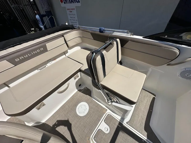 Slide: The Image of 2017 Bayliner VR5 Bowrider interior with beige seating and carpeted flooring. - 17