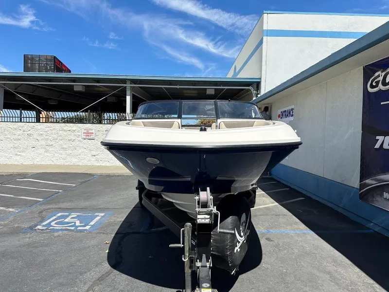Slide: The Image of 2017 Bayliner VR5 Bowrider boat on trailer in parking lot, sunny day. - 2