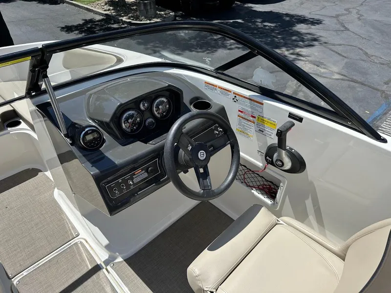 Slide: The Image of 2017 Bayliner VR5 Bowrider cockpit with steering wheel, gauges, and throttle controls. - 22
