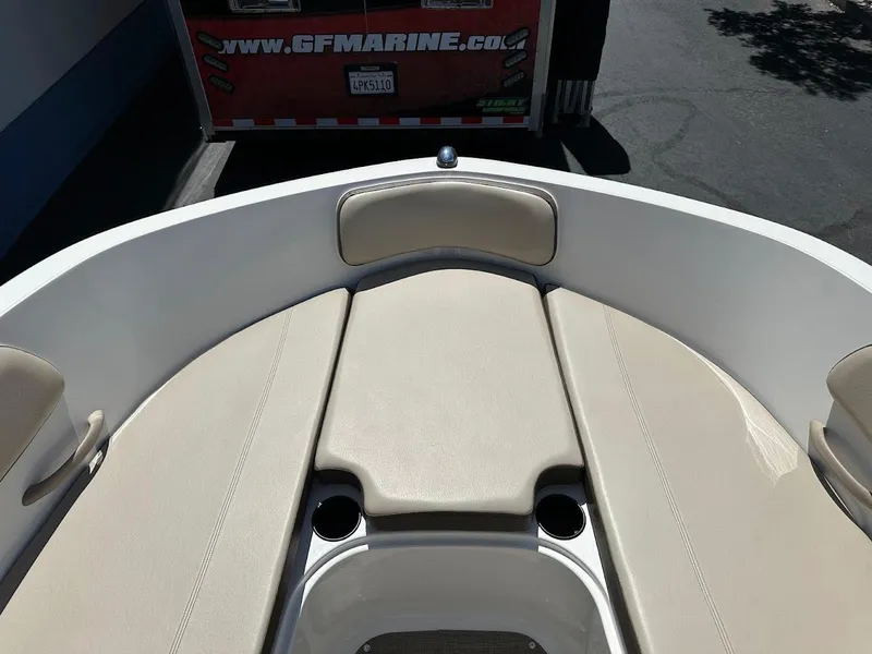 Slide: The Image of 2017 Bayliner VR5 Bowrider boat interior with beige seating and cup holders. - 29
