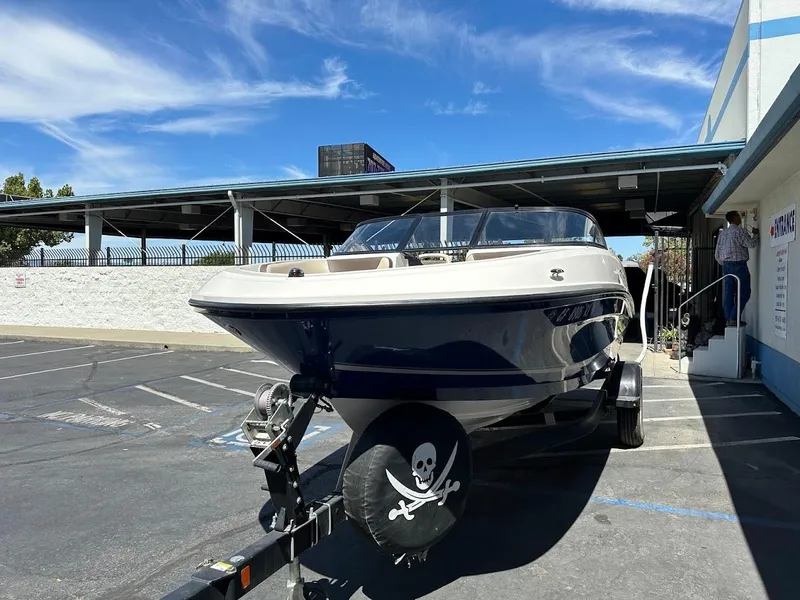Slide: The Image of 2017 Bayliner VR5 Bowrider on trailer in parking lot, clear sky background. - 3