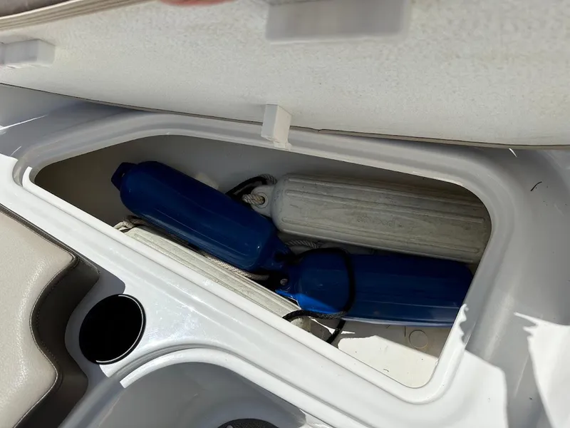 Slide: The Image of Storage compartment in a 2017 Bayliner VR5 Bowrider with blue boat fenders. - 32
