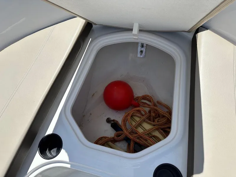 Slide: The Image of Storage compartment in a 2017 Bayliner VR5 Bowrider with rope and red buoy. - 33
