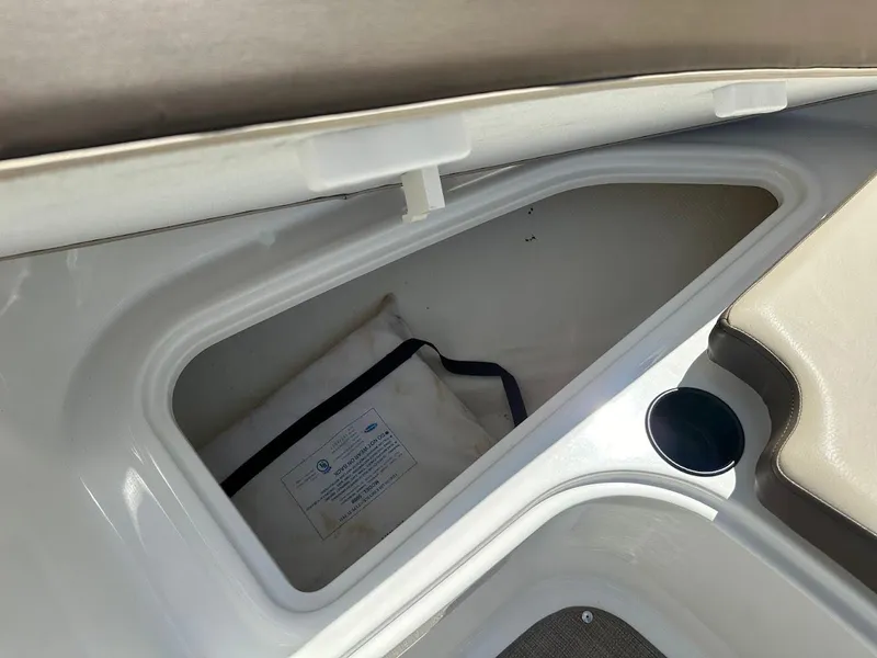 Slide: The Image of Storage compartment in 2017 Bayliner VR5 Bowrider boat with cup holder and cushion. - 34