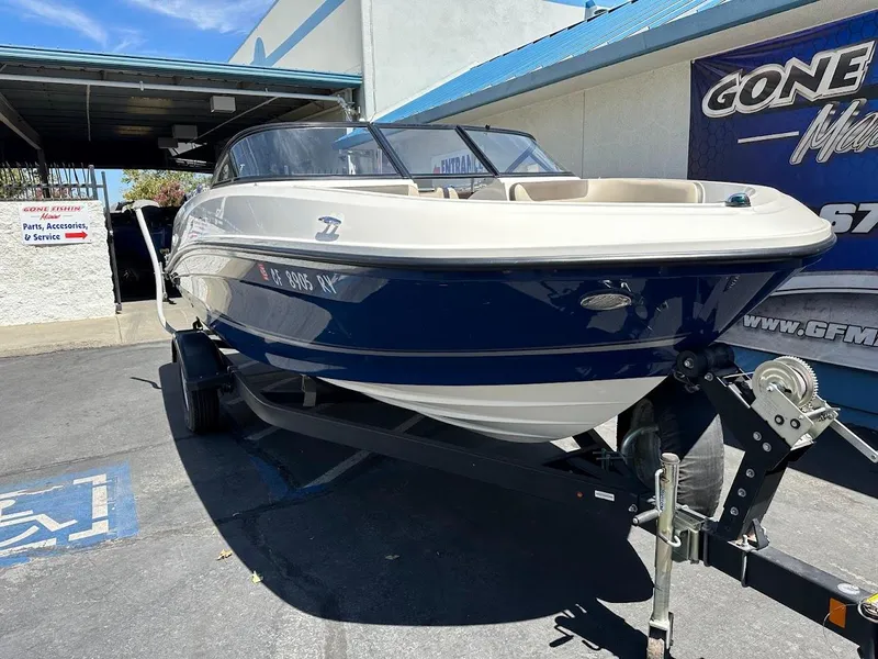 Slide: The Image of 2017 Bayliner VR5 Bowrider on trailer, parked outside a service center. - 5