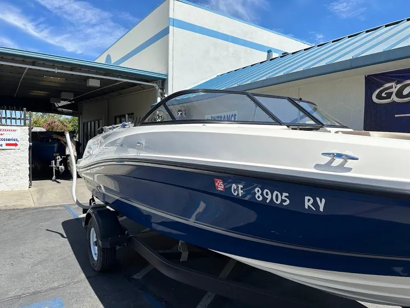 Slide: The Image of 2017 Bayliner VR5 Bowrider boat parked outside a building under a clear blue sky. - 6