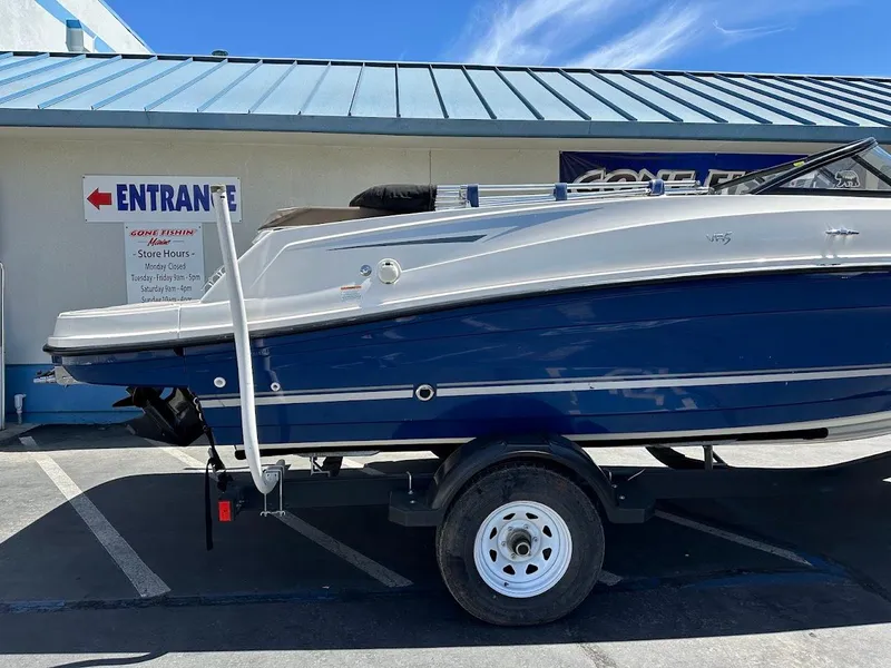 Slide: The Image of 2017 Bayliner VR5 Bowrider boat on trailer, parked outside a building. - 7