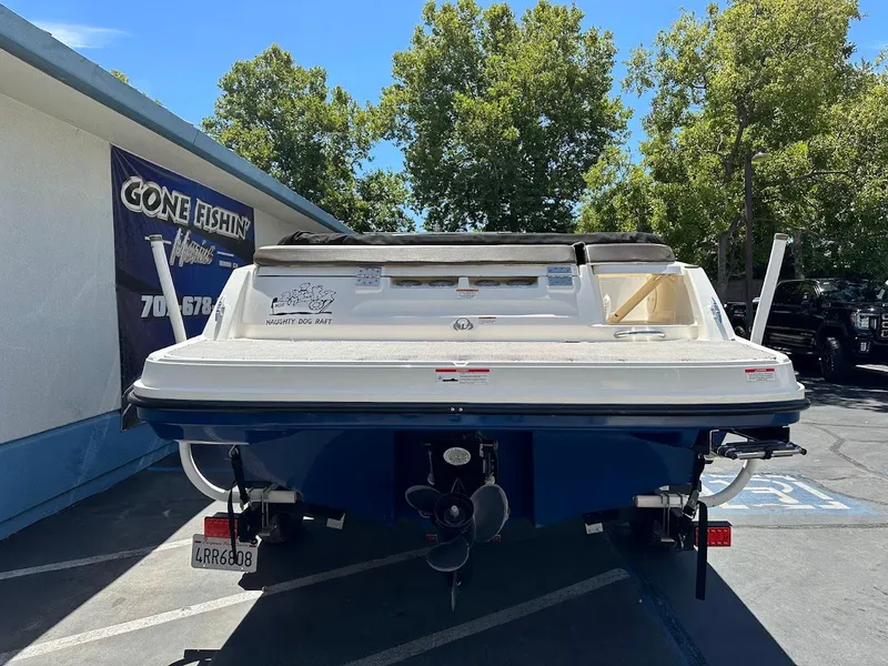 Slide: The Image of 2017 Bayliner VR5 Bowrider boat parked outdoors, rear view, sunny day. - 9