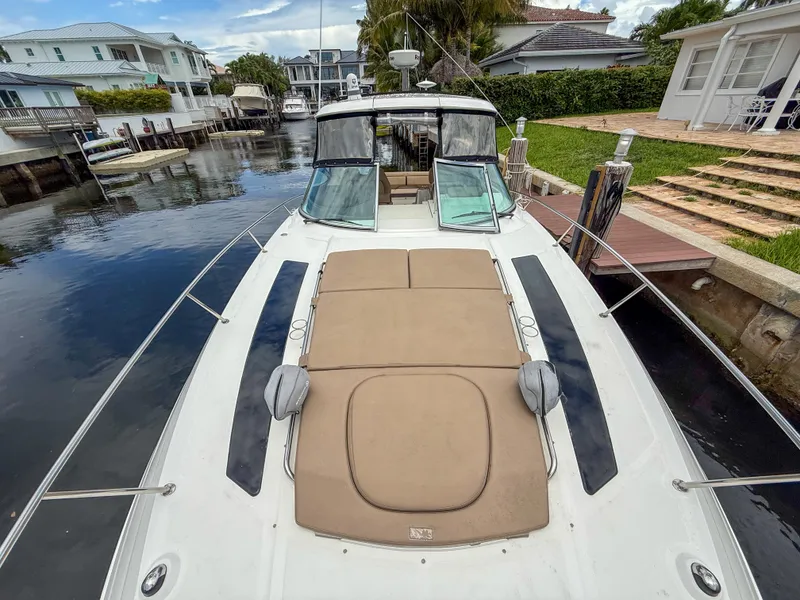 Slide: The Image of 2016 Sea Ray 350 Sundancer yacht docked in a residential canal setting. - 14