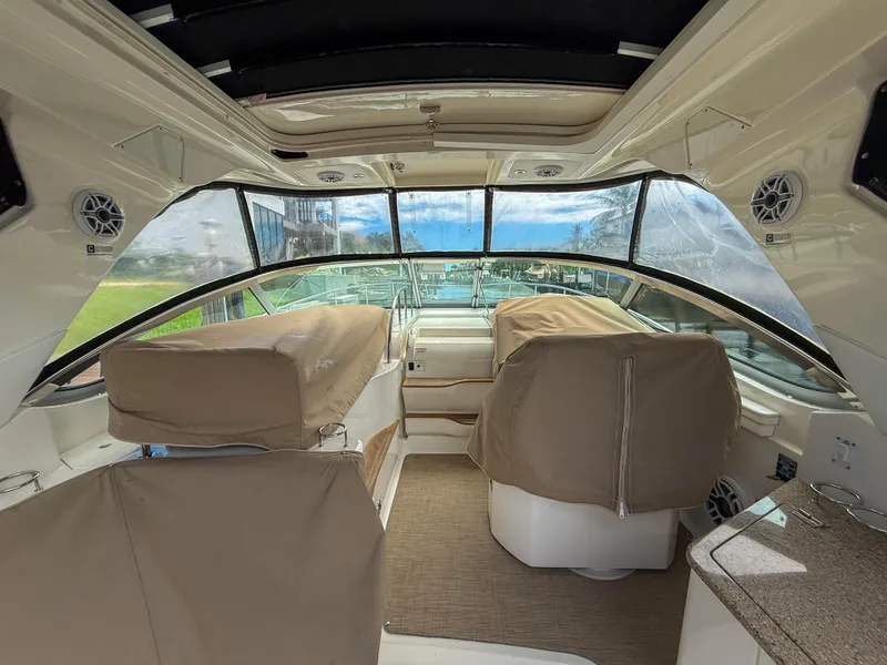 Slide: The Image of Interior view of 2016 Sea Ray 350 Sundancer yacht with covered seats and panoramic windows. - 34