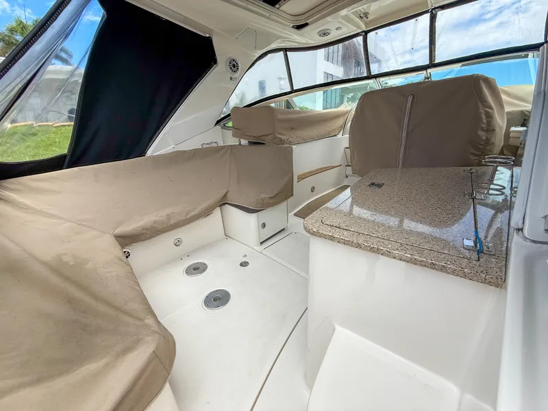 Slide: The Image of 2016 Sea Ray 350 Sundancer interior with beige seating and granite countertop. - 36
