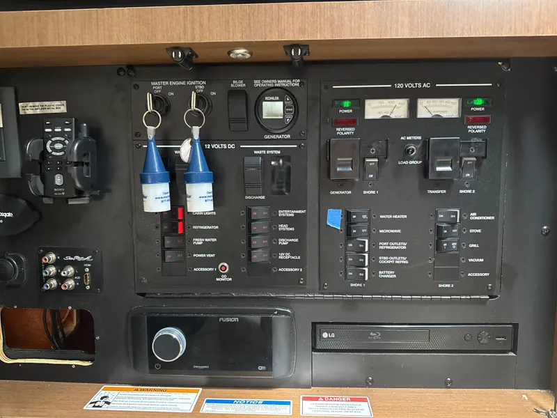 Slide: The Image of Control panel of a 2016 Sea Ray 350 Sundancer boat with various switches and meters. - 41