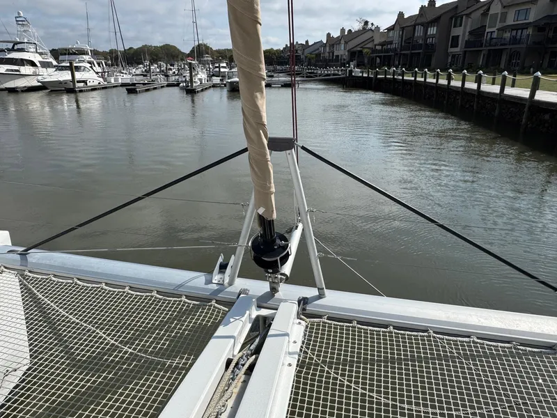 Slide: The Image of Lagoon 46 catamaran (2022) docked in a marina, showcasing its netted bow area. - 12