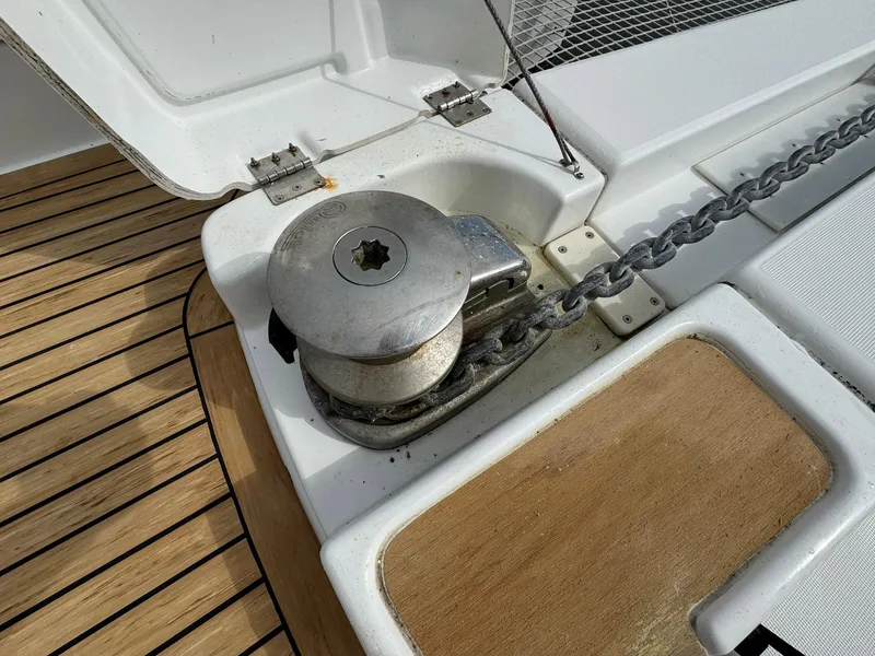 Slide: The Image of Anchor winch on 2022 Lagoon 46 yacht deck with chain and wooden flooring. - 14