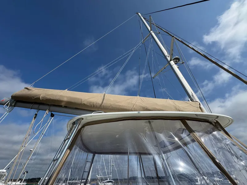 Slide: The Image of 2022 Lagoon 46 sailboat mast and canopy under a clear blue sky. - 16