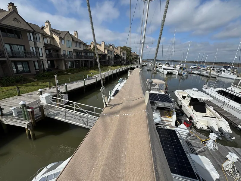 Slide: The Image of Lagoon 46 catamaran docked at marina, surrounded by boats and waterfront homes, 2022 model. - 24