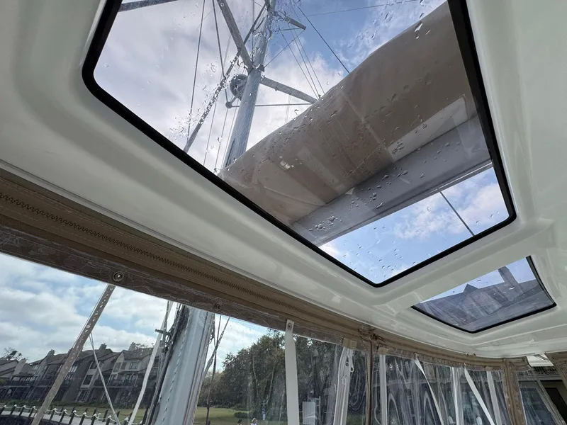 Slide: The Image of Interior view of 2022 Lagoon 46 catamaran with skylights and mast visible. - 27