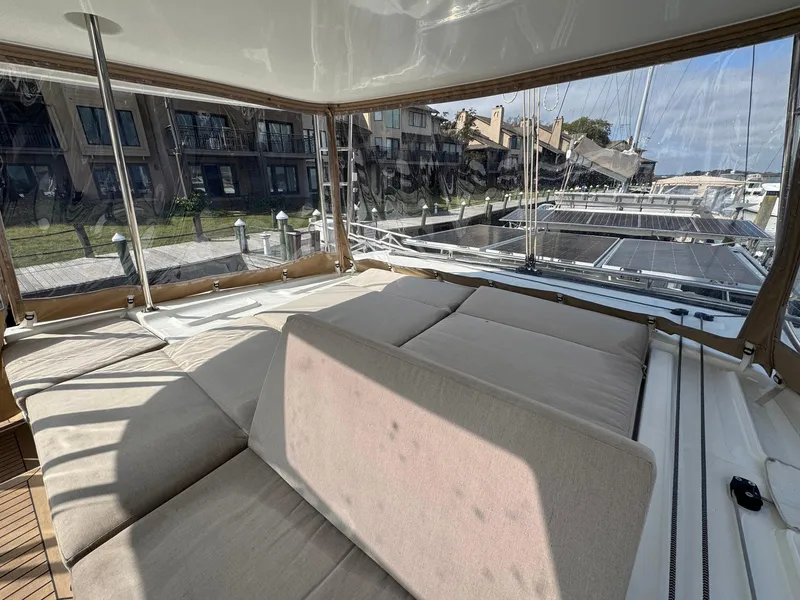 Slide: The Image of Luxurious Lagoon 46 catamaran interior, 2022 model, featuring spacious seating and marina view. - 28