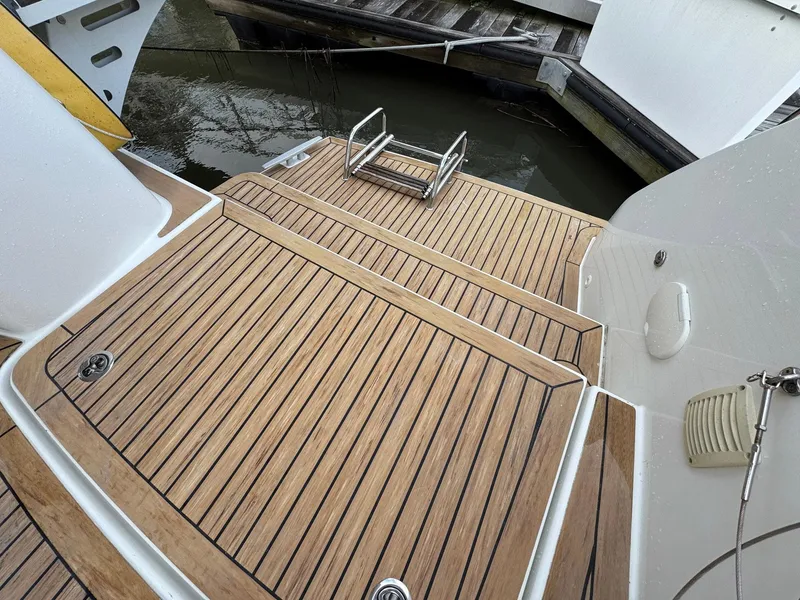 Slide: The Image of 2022 Lagoon 46 yacht with teak deck and swim ladder in marina. - 38