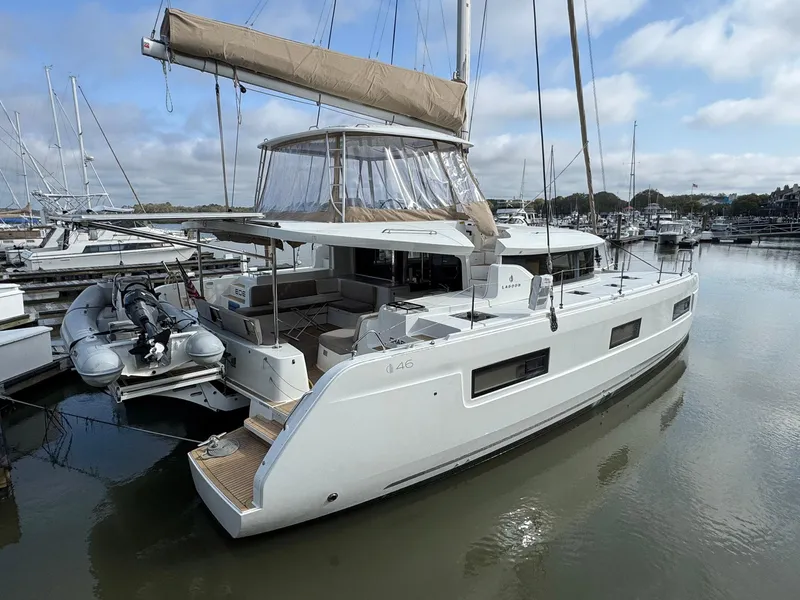Slide: The Image of 2022 Lagoon 46 catamaran docked at marina, featuring modern design and spacious deck. - 4